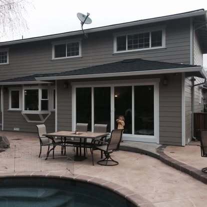 Backyard remodel with sliding glass doors and poolside patio