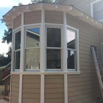 Finished bay window addition with custom siding and trim